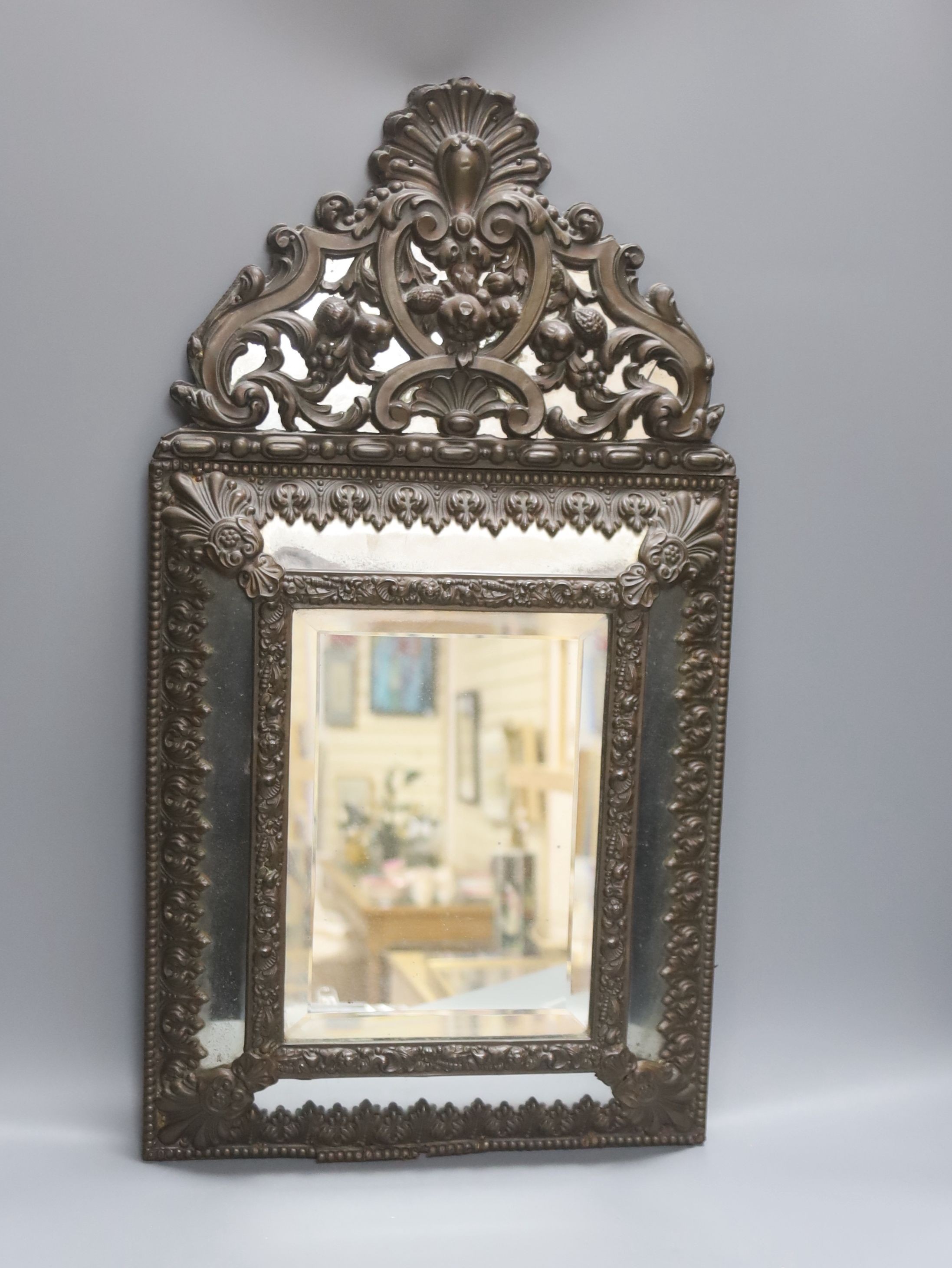 A 19th century Dutch embossed copper mounted wall mirror 58cm